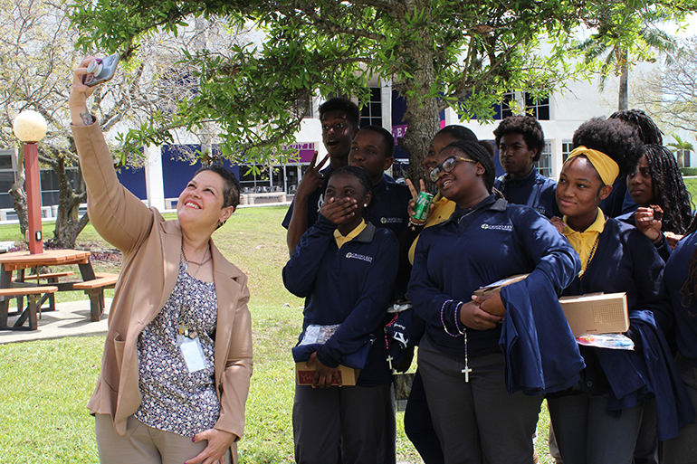 March 22, 2023
MIAMI GARDENS

Brunilda Egan, campus ministry director at Cristo Rey High School in North Miami, takes a selfie with her students on the grounds of St. Thomas University. On March 22, 2023 St. Thomas University welcomed high schools from the Archdiocese of Miami for a kick off gathering for the National Eucharistic Revival, featuring guest speaker Katie Prejean McGrady.