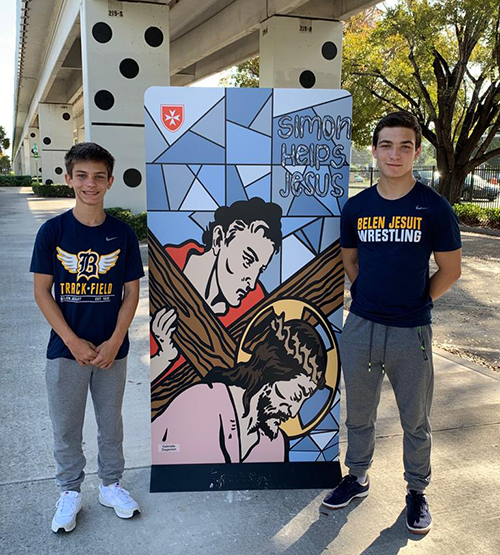Belen Jesuit Prep eighth-grader John Amador, left, and 11th-grader Henry Amador man the Fifth Station of the Via Crucis, April 1, 2023. All of the Stations of the Cross images were created last year by art students at Our Lady of Lourdes Academy.