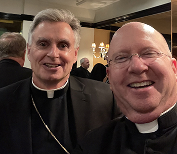 Father Michael Davis, right, pastor of St. Gregory the Great Parish in Plantation, takes a selfie with Spokane, Washington Bishop Thomas Daly, keynote speaker at the  Catholic Education Foundation's Honors Night, where Father Davis received a Lifetime Achievement Award, April 26, 2023, in New York.