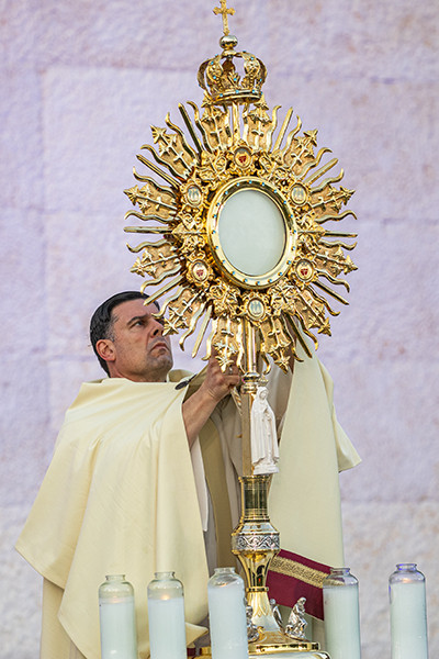 Father Rafael Capó, vice president of Mission at St. Thomas University in Miami Gardens, holds the monstrance during adoration at an EPIC Night of Mercy event celebrated at the university in April 2021. Father Capó is one of 50 priests selected as "Eucharistic preachers" for the nationwide Eucharistic Revival. Two others also are from the Archdiocese of Miami: Father Elvis Gonzalez, pastor of St. Michael the Archangel Church in Miami, and Father Joseph Jean-Louis, administrator of Christ the King Church in Perrine.