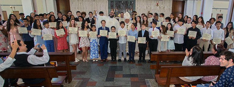 Father Matthew Gomez, archdiocesan vocations director, jokingly takes a selfie as altar servers pose for a group photo with their awards at the conclusion of the annual Mass and Altar Server Awards ceremony sponsored by the Miami Serra Club. It took place April 30, 2023, at St. Raphael Chapel on the campus of St. John Vianney College Seminary in Miami, with Auxiliary Bishop Enrique Delgado presiding.