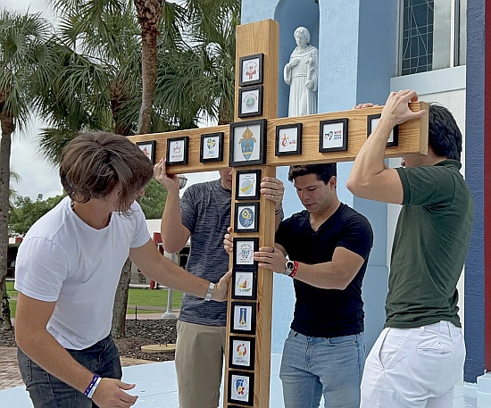 Young men set up an emblematic cross at St. Thomas University for the upcoming World Youth Day. The cross was a focus for the recording November 2022 of "Feel the Rush in the Air," the theme song for WYD 2023. The cast was made of STU students, plus youths from around the Archdiocese of Miami.