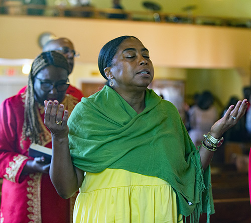 Nadine Shim recites the "Lord's Prayer" during the Unity Mass sponsored by the archdiocese's Black Catholic Ministry, June 25, 2023.