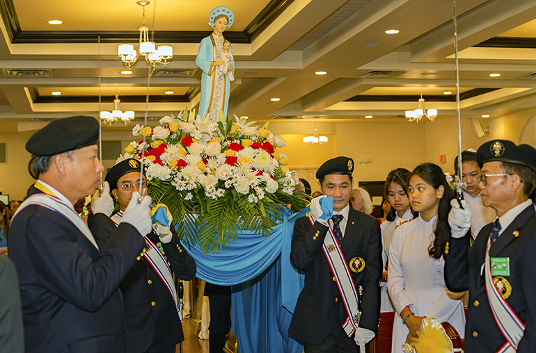Knights of Columbus carry Our Lady of La Vang into church for the July 2, 2023 Mass where Archbishop Thomas Wenski formally elevated the church from a mission to a parish for the Vietnamese community.
