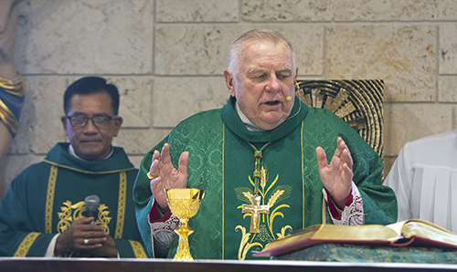 Archbishop Thomas Wenski concelebrates Mass with Father Joseph Long K. Nguyen, pastor of Our Lady of La Vang, July 2, 2023, the day the archbishop formally elevated the church from a mission to a parish for the Vietnamese community.