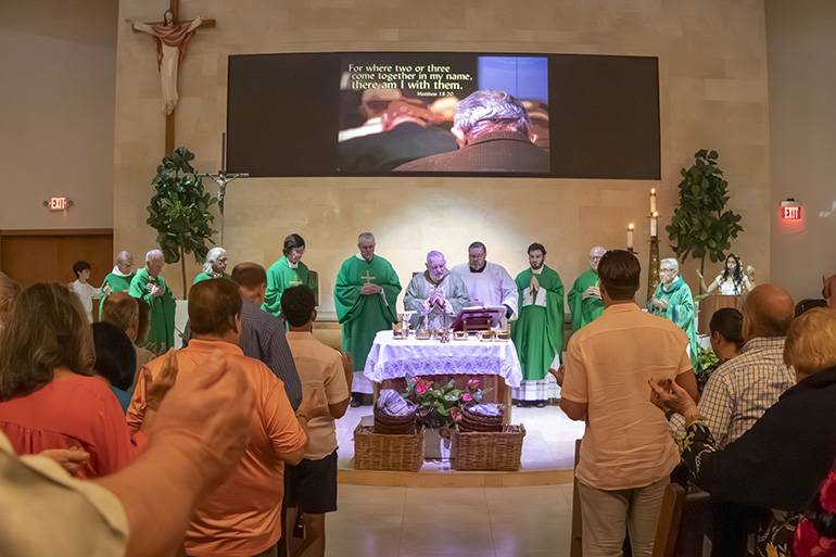 Archbishop Thomas Wenski consecrates the Eucharist at the Mass celebrating the 60th anniversary of St. Louis Church in Pinecrest, Sept. 10, 2023.