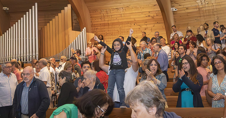 Nicolas Piedra is lifted up in celebration by his father, Ricardo, at the conclusion of the Mass celebrating St. Louis Church’s 60th anniversary, Sept. 10, 2023.