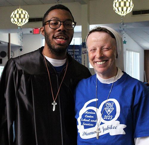 Marian Center student Octavis Williams, who played the role of Archbishop Coleman Carroll in a school play, poses with Sister Lidia Valli, principal of the Marian Center School and Services. The Marian Center is currently celebrating their 60th anniversary.