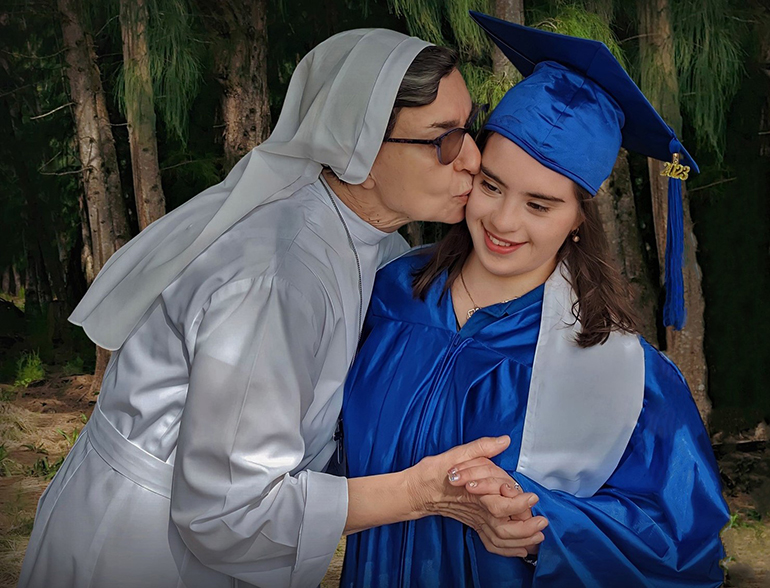 Sister Fausta Rondena gives a hug and a kiss to Meilani Perdomo who graduated with the Class of 2023 from the Marian Center School in Miami Gardens. Meilani was a student at the Marian Center for 15 years. The Marian Center School and Services is currently celebrating their 60th anniversary.