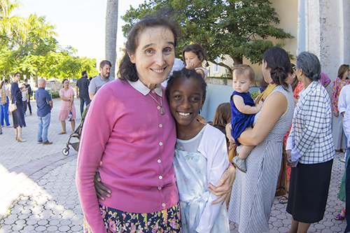 Gianna Emanuela, daughter of St. Gianna Beretta Molla and Pietro Molla, embraces fifth-grader Gianna Francesca Dophinis at the conclusion of the Mass launching the St. Gianna and Pietro Molla Miscarriage Ministry, Oct. 15, 2023.