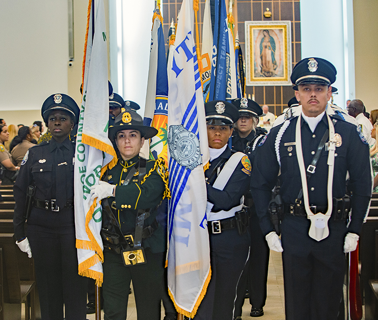 Representatives of local police departments process out of Our Lady of Guadalupe Church in Doral at the conclusion of the Blue Mass, celebrated on the feast of St. Michael, Sept. 29, 2023.