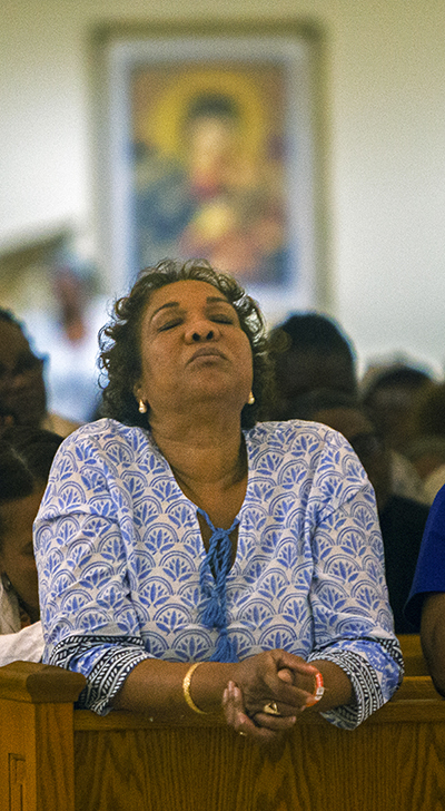 Kathleen Kehly Derival prays on the third night of Notre Dame d'Haiti's annual celebration of Jericho, Oct. 15-21, 2023, in Miami.