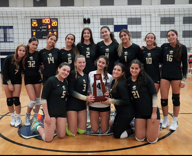 Immaculata-La Salle High School's girls varsity volleyball team pose with their trophy after winning their second straight district championship, Oct. 19, 2023.