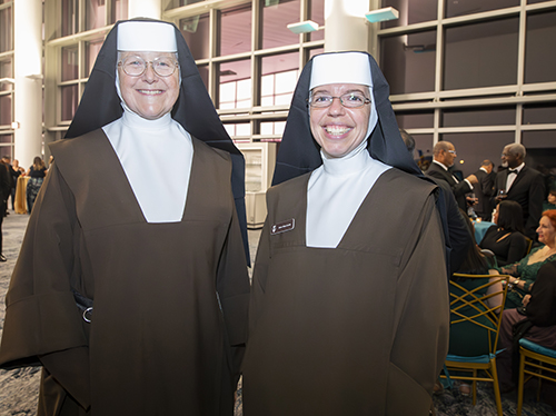 Carmelite Sisters Margaret Ann and Mary Louise, principal and theology teacher, respectively, at Archbishop Coleman Carroll High School in Miami, prepare to join nearly 900 others at the 65th anniversary gala for the Archdiocese of Miami, Nov. 11, 2023, at the Miami Beach Convention Center. The gala raised over .8 million for the archdiocese's educational programs.