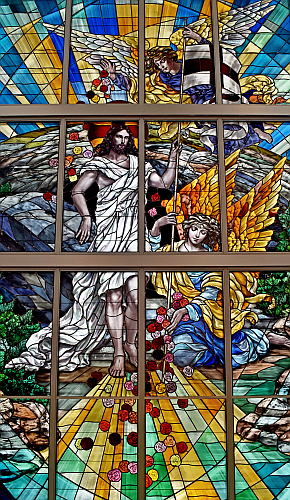 An angel showers roses on the risen Jesus as another paves his paths with more roses, in this window at Our Lady of Guadalupe Church in Doral.