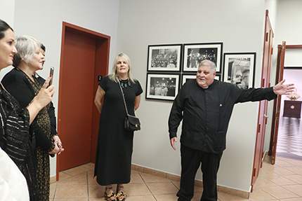 El P. Espino, rector de la Ermita de la Caridad de Miami da la bienvenida a los asistentes a la exposición de arte cubano contemporáneo "Vuelve a Nosotros Tus Ojos. La Caridad Nos Une", el 4 de diciembre, en el salón Padre Félix Varela del santuario de la Ermita. Lo acompaña la curadora de la exposición, Sandra Contreras.