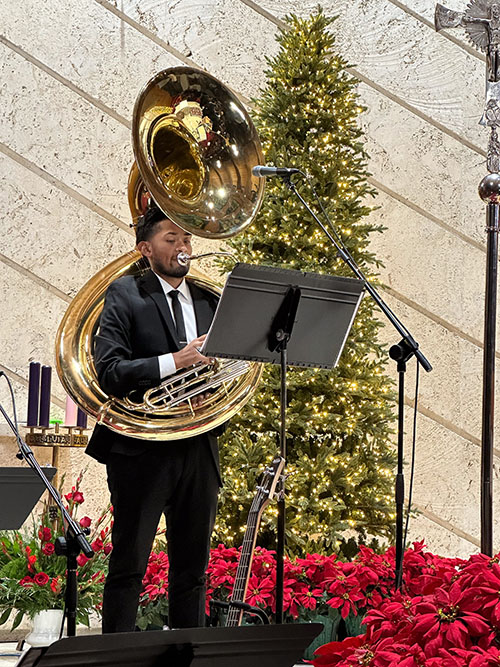 A seminarian plays the tuba, one of the instruments featured in the Redemptoris Mater seminary choir's last of four Christmas concerts, at Our Lady of the Lakes, Miami Lakes, Dec. 22, 2023.
