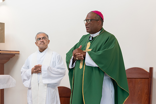 Archbishop Patrick C. Pinder of Nassau, Bahamas, accompanied by Msgr. Roberto Garza, chairman of the board of Catholic Charities, celebrates Mass for the Miami archdiocesan delegation that visited at the end of November, at the newly rebuilt and dedicated Sts. Mary and Andrew Church in Treasure Cay, Abaco. The old church was completely destroyed during by Category 5 Hurricane Dorian in 2019.