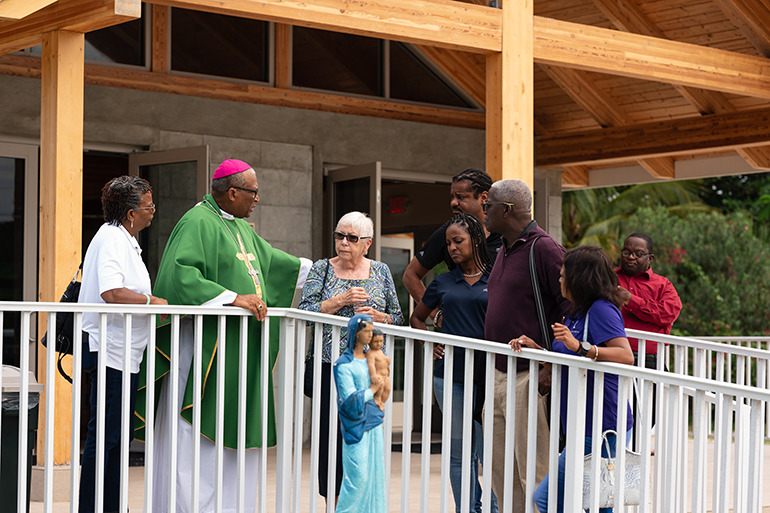Archbishop Patrick C. Pinder of Nassau, Bahamas, meets with parishioners after celebrating Mass at the newly rebuilt and newly dedicated Sts. Mary and Andrew Church in Treasure Cay, Abaco, for a Miami archdiocesan delegation that visited in November. The old church was completely destroyed during by Category 5 Hurricane Dorian in 2019.