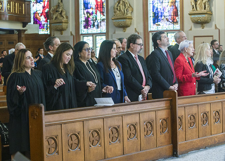 Reciting the Lord's Prayer at the 2023 Miami Catholic Lawyers Guild Red Mass, from left: Circuit Court Judge Ariana Fajardo Orshan, Circuit Court Judge Gina Beovides, Circuit Court Judge Bertila Soto, Chief Circuit Court Judge Nushin Sayfie, Federal Magistrate Judge Jonathan Goodman, U.S. District Court Judge Rodolfo Ruiz, U.S. District Court Judge Patricia Seitz, and Chief U.S. District Court Judge Cecilia Altonaga.