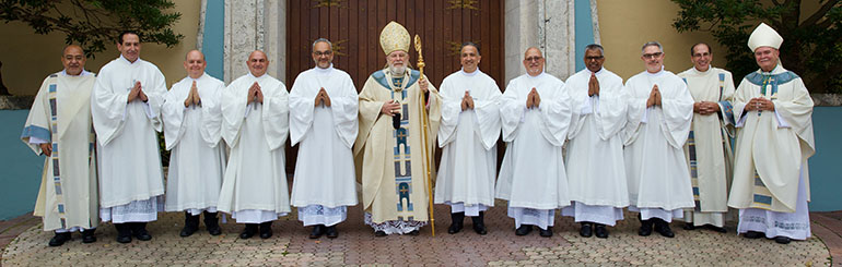 The new deacons pose outside St. Mary Cathedral after the ordination Mass, Dec. 16, 2023; from left: Deacon Victor Pimentel, director of the Office of the Permanent Deaconate; newly ordained deacons Charles Villar, Robert Velez, Victor Martinez and Jorge Escobar; Archbishop Thomas Wenski; newly ordained deacons Andrew Hernandez, Robert Puyada, Srinath Perera and Nicolas Diaz; Deacon Sergio Rodicio of St. Mary Cathedral; and Bishop Fernando Isern.