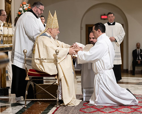 Soon-to-be Deacon Charles Villar promises obedience to Archbishop Thomas Wenski and his successors during the ordination Mass, Dec. 16, 2023, at St. Mary Cathedral.