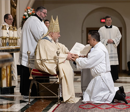Soon-to-be Deacon Andrew Hernandez promises obedience to Archbishop Thomas Wenski and his successors during the ordination Mass, Dec. 16, 2023, at St. Mary Cathedral.