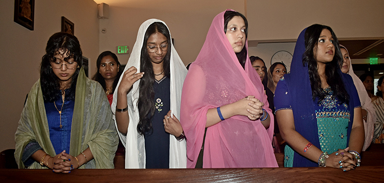 Young women with St. Mary's Syro-Malankara Church Don veils for Qurbono, an Indian Mass, at Nativity Church in Hollywood Jan. 14, 2024. The Mass was part of a visit by Bishop Philipos Mar Stephanos, shepherd of Syro-Malankara Catholics in the U.S. and Canada.