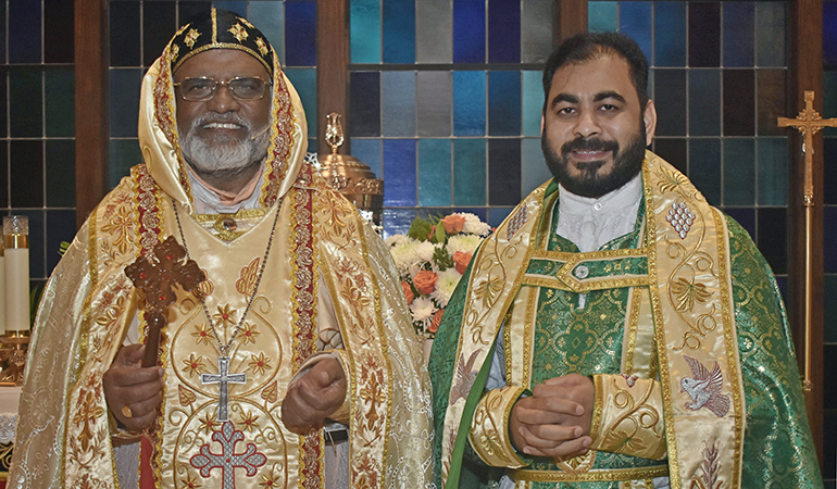 Bishop Philipos Mar Stephanos Thottathil, in gold vestments, poses after Qurbono, or Mass, at Nativity Church in Hollywood Jan. 14, 2024. Beside him is Father Santhosh Thomas, pastor at St. Mary's Syro-Malankara Church in Hollywood.