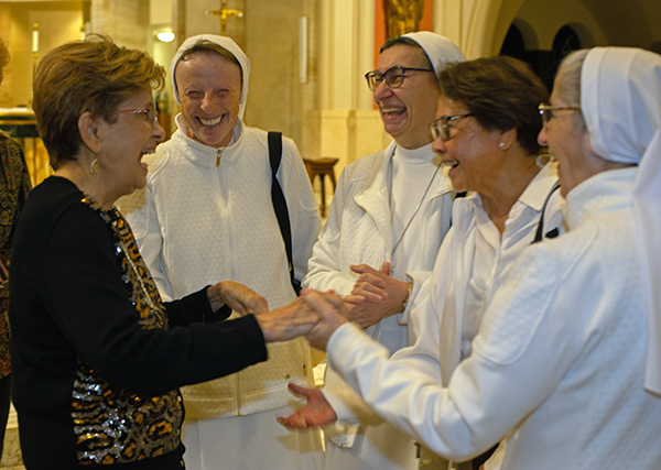 Adrian Dominican Sister Evelyn Piche, far left, a 70-year jubilarian, shares a laugh with Sisters of St. Joseph Benedict Cottolengo from the Marian Center, from left: Sister Lidia Valle, Sister Fausta Rondena, Daisy LoFranco, a Marian Center aggregate, and Sister Filomena Mastrangelo after the Mass marking the World Day of Prayer for Consecrated Life, celebrated Feb. 3, 2024, at St. Mary Cathedral.