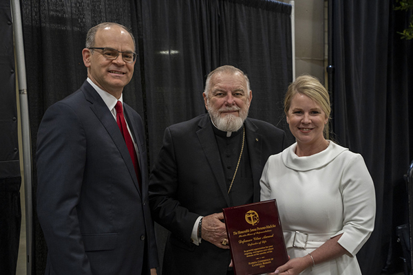 Michael B. Sheedy, executive director of the Florida Conference of Catholic Bishops, and Miami Archbishop Thomas Wenski present Rep. Jenna Persons-Mulicka with the Defensor Vitae Award during a breakfast at Catholic Days at the Capitol, Feb. 7, 2024. In 2023, Rep. Persons-Mulicka (R-Fort Myers) was the House sponsor of legislation prohibiting abortion after six-weeks gestation and steered her bill to final passage.