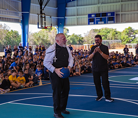 Archbishop Thomas Wenski inaugurated the basketball court, part of the new airnasium, as he plays basketball with Father Jaime Acevedo, pastor of St. Mark Church. The structure was blessed by Archbishop Thomas Wenski on Feb. 26, 2024.