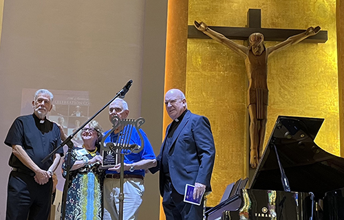 Julie A.S Williamson, President and Founding Chair of Martha/Mary concerts and her husband Bob received a recognition plaque from Father Jose Luis Menendez (left), pastor of Corpus Cristi and Father Federico Capdepon, April 28, 2024, at Corpus Christi Parish in Miami.