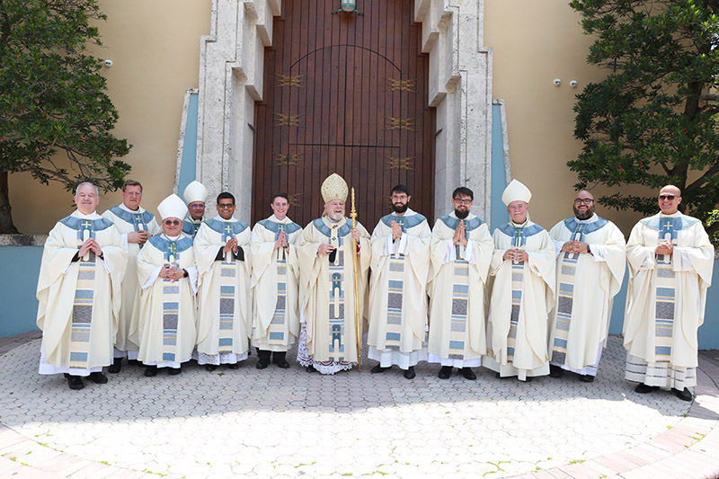 Archbishop Thomas Wenski poses with the four men he ordained May 11, 2024, at St. Mary Cathedral along with the bishops and seminary rectors who took part in the ceremony; from left: Father Alfredo Hernandez, rector of St. Vincent de Paul Regional Seminary; Father Emanuele De Nigris, rector of Redemptoris Mater Archdiocesan Missionary Seminary, Miami; Auxiliary Bishop Enrique Delgado; Bishop Silvio Baez, auxiliary of Managua, Nicaragua; Father Milton Martínez, Father John Buonocore, Archbishop Wenski, Father David Zallocco, Father Piotr Sawicki, Bishop Fernando Isern, emeritus of Pueblo, Colorado; Father Matthew Gomez, archdiocesan vocations director, and Father Christopher Marino, rector of St. Mary Cathedral.