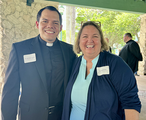 Father Nicholas Toledo, parochial vicar at St. John Neumann, in Miami, and Sue DeFerrari, executive director of MorningStar Renewal Center in Pinecrest, smile for the camera at the Miami’s Community News Pinecrest Luncheon with Archbishop Thomas Wenski May 15, 2024, at Evelyn Greer Park, in Pinecrest.