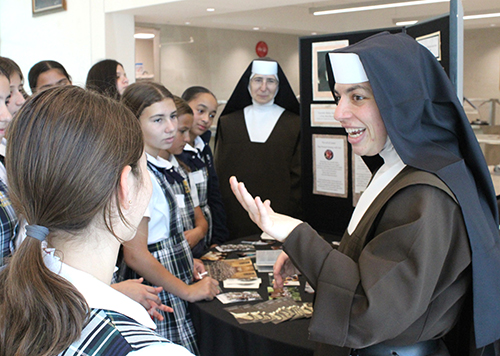 Carmelite Sister Myriam Falzon explains her vocational life as a religious to students from St. Theresa School in Coral Gables during the Focus 11 vocations rally in St. John Vianney College Seminary, May 21, 2024. Also helping at the table was Carmelite Sister Lucia Mercica.
