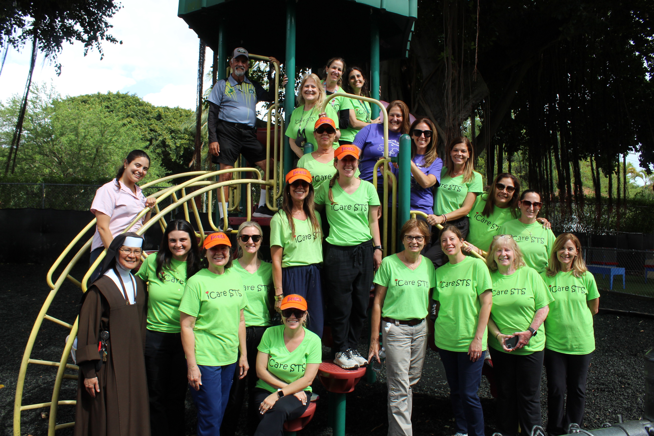 Some of the St. Theresa School faculty and staff who took part in the fitness walking challenge during the 2023-24 school year, along with their challenger, Coach Frank Ramos at rear, pose for a photo on the school grounds.