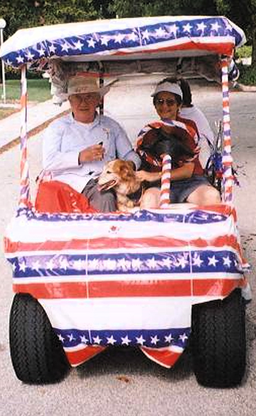 File photo of Anne Gardner and Msgr. Patrick McDonnell, former pastor of St. Sebastian Parish, in a cart exploring the parish grounds in 1995 when both arrived at the parish in Fort Lauderdale.