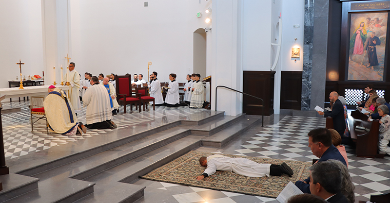 Archbishop Thomas Wenski and the congregation pray the Litany of the Saints as Deacon Michael Anthony Martínez, who is going to be ordained to the priesthood, lies prostrate in the sanctuary of Our Lady of Belen Chapel in Miami, June 1, 2024.



Archbishop Thomas Wenksi ordained Michael Anthony Martinez, S.J., to the priesthood on June 1, 2024, at the Our Lady of Belen Chapel.