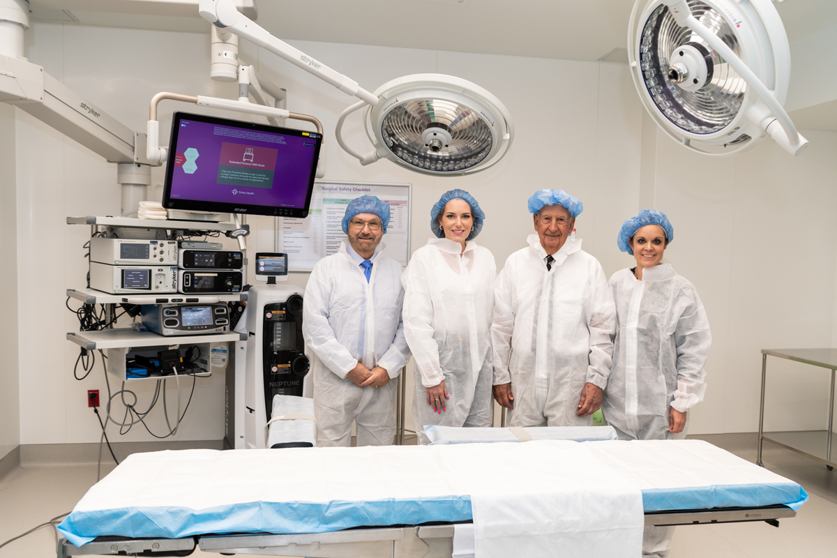 Holy Cross Health in Fort Lauderdale unveiled seven newly renovated surgical rooms made possible by a donation from The Harry T. Mangurian Jr. Foundation. Standing inside one of them in this photo is Rudy Molinet, RN, chair of the Holy Cross Health board of directors; Laura Denoux, vice president and chief development officer at Holy Cross; Steve Mehallis, president of The Harry T. Mangurian Jr. Foundation; Brittany Henson, development officer at Holy Cross.