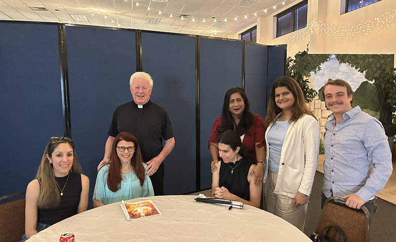 Father Edmond Prendergast, pastor of St. Bonaventure in Davie, poses with some participants of the parish's Singles Ministry at their monthly meeting on May 18, 2024.