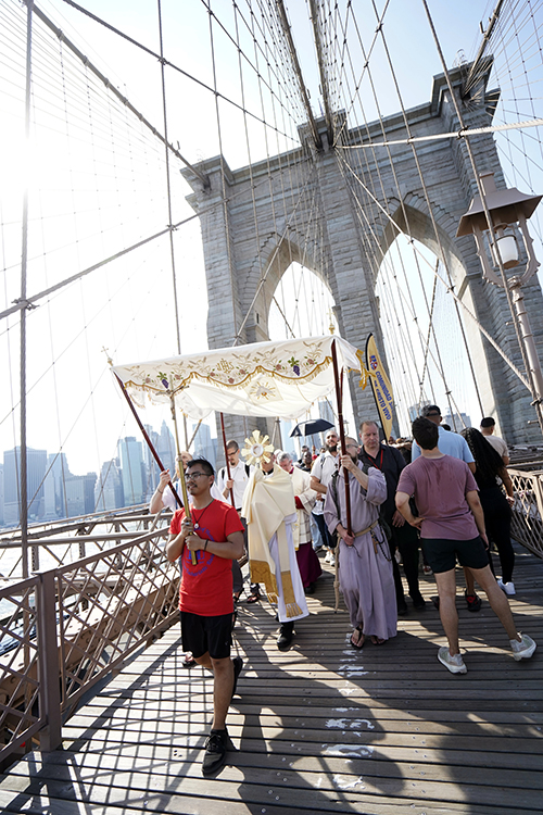 Bishop Robert J. Brennan of Brooklyn, N.Y., carries the monstrance while leading a Eucharistic procession across the Brooklyn Bridge from Manhattan to Brooklyn on the National Eucharistic Pilgrimage's Seton (East) Route May 26, 2024.