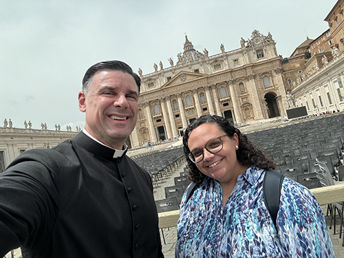 Father Rafael Capó and Isabelle Seiglie of St. Thomas University take a selfie at St. Peter's Square during the International Congress on Ministry with Young People May 23-25, 2024.