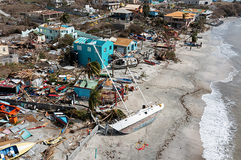 Scattered debris, a sailboat and houses with missing roofs are seen in a drone photograph July 2, 2024, after Hurricane Beryl passed the island of Petite Martinique, Grenada. (OSV News photo/Arthur Daniel, Reuters)