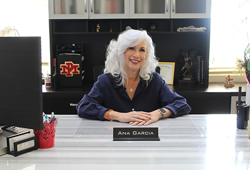 Ana Garcia Principal of Monsignor Edward Pace High School poses at her desk. At the end of the 2023-2024 academic year, Garcia retired after 25 years dedicated to Catholic school education, 20 as principal, and five as assistant principal at Pace.