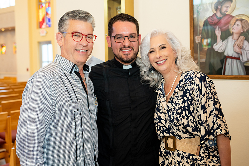 Outgoing archdiocesan principals Eddy Garcia, left, and Ana Garcia pose with their son, Father Bryan Garcia, St. John Vianney's vice-rector and dean of seminarians. Eddy was principal of St. Louis Covenant School in Pinecrest, and Ana Garcia was principal of Msgr. Edward Pace High School in Miami Gardens.
