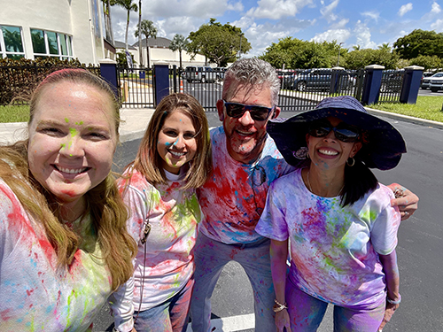 St. Louis Covenant Principal Eddy Garcia poses with some of his staff at a color war activity. From left, school counselor Mary Jesurun, assistant principal Annie Baixauli and curriculum and instruction director, Christina Rivera-Izquierdo.