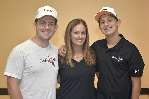 Ileana McGoohan poses with sons Eric Gutierrez, left, and Nico Gutierrez. The family started Loving Soles in 2011. Since then, the student-led charity has collected 50,000 pairs of shoes for Camillus House, a homeless shelter in Miami.