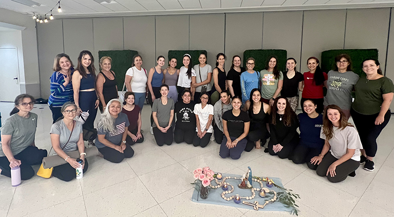 Participants smile for the camera after the Saturday, July 27, 2024, SoulCore class at the St. Louis Parish Family Center. The SoulCore movement involves praying the rosary while engaging in light exercises designed to promote contemplation.