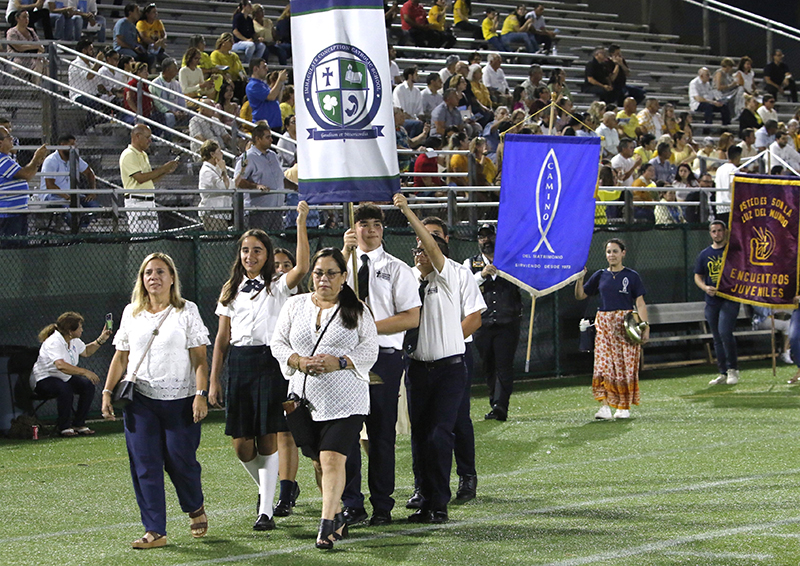 Banners from different ministries and schools of the Archdiocese of Miami enter Milander Park in Hialeah, at the beginning of the Mass in honor of Our Lady of Charity, held this year Sept. 7, 2024.